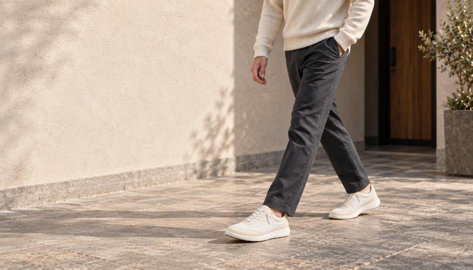 Footle Mesh Beige styled with knitwear and dark trousers in an everyday courtyard